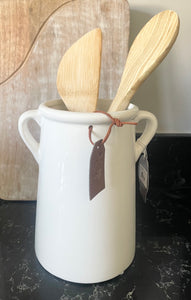 A classic white ceramic vase with small eared handles.